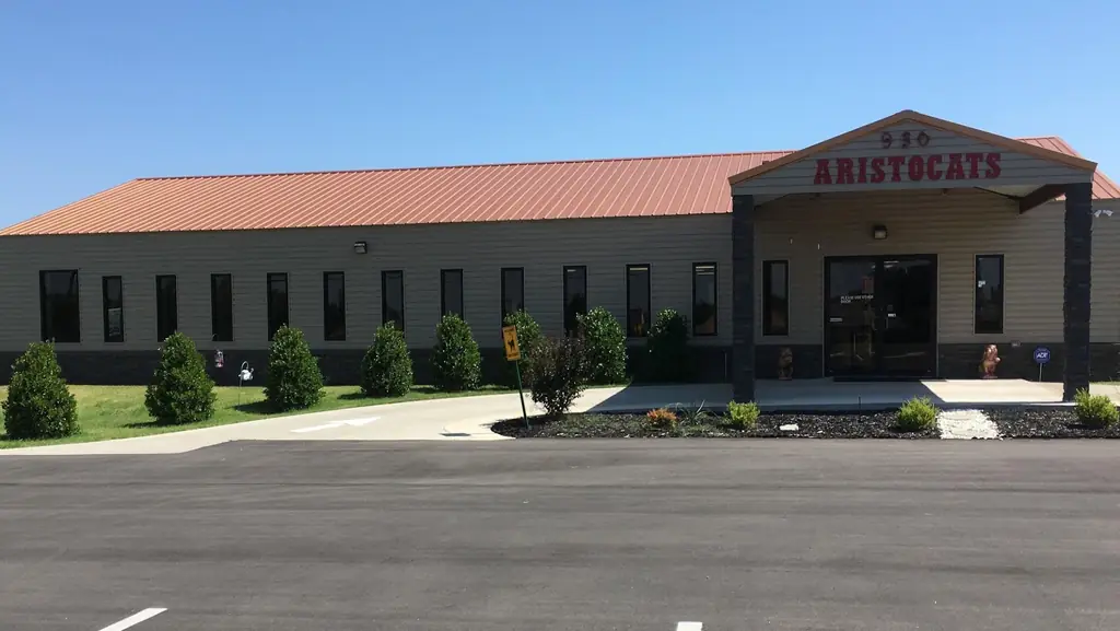The Aristocats building on West Hefner Road in Oklahoma City, with its red roof and covered entrance